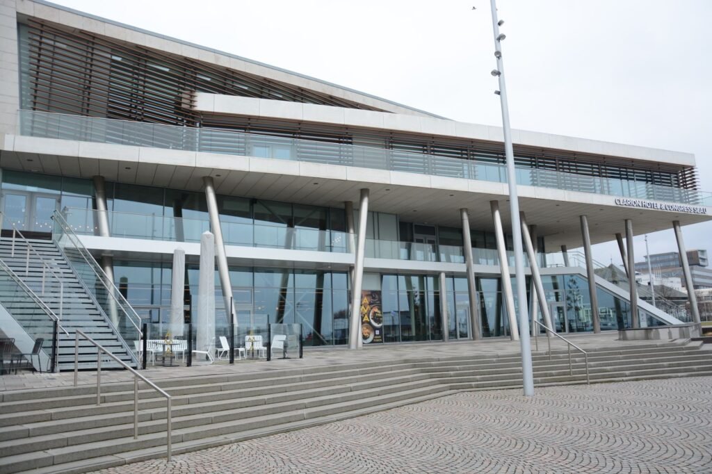 Front view of the Clarion Hotel & Congress with its modern architectural design and glass facade.