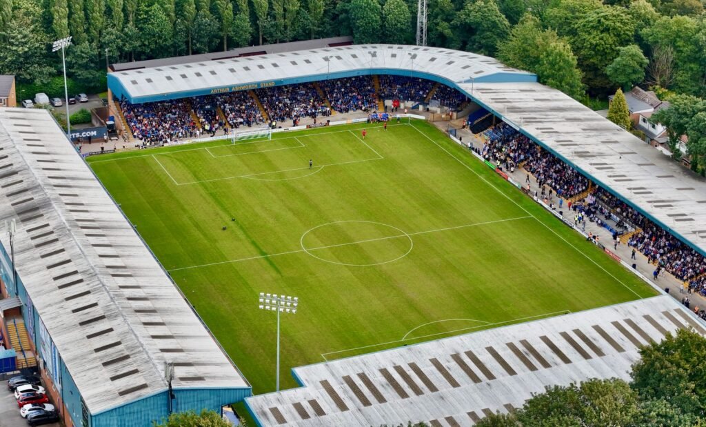 Aerial shot of a bustling football stadium in Bury, England. Ideal for sports and event themes.
