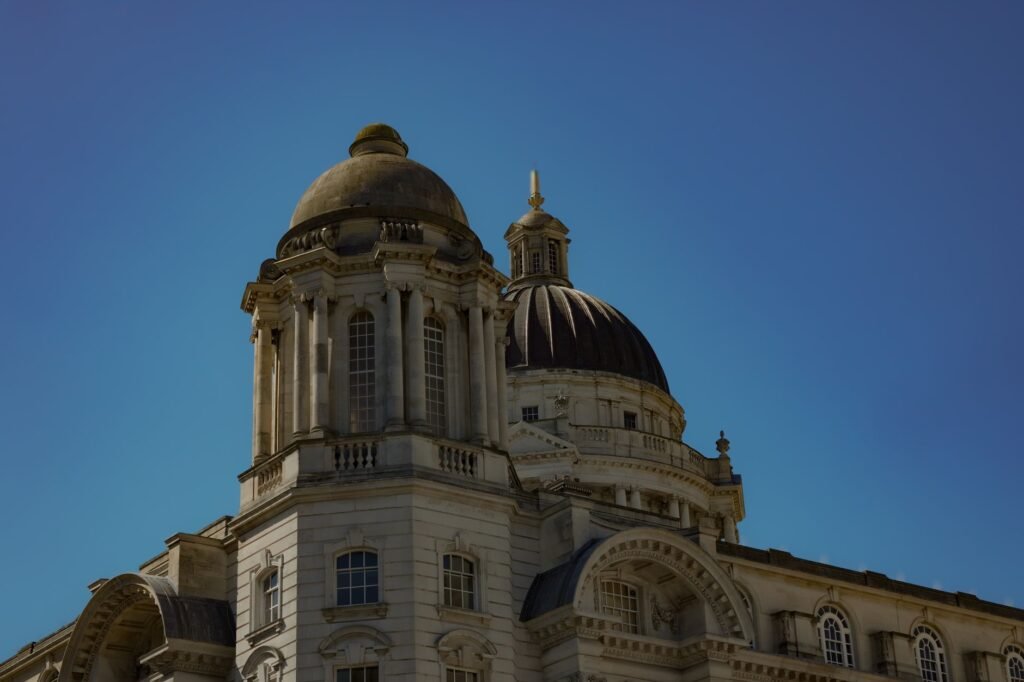 Captivating view of a historic Liverpool building's dome against a clear blue sky, showcasing classical architecture.