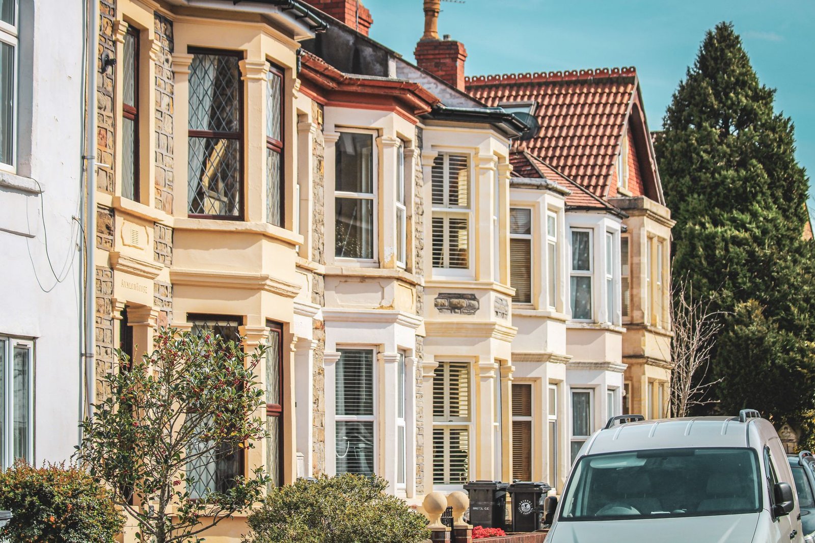 Elegant row houses with classic architecture on a sunny street in Bristol, UK.