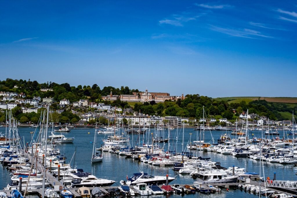 Discover the picturesque Dartmouth Marina in England with boats and stunning landscape.