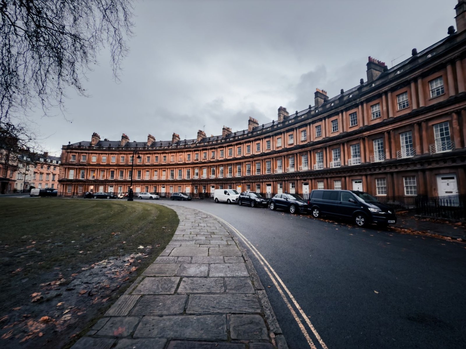 Capturing the classic Georgian architecture of the Circus in Bath, England, on a cloudy day.