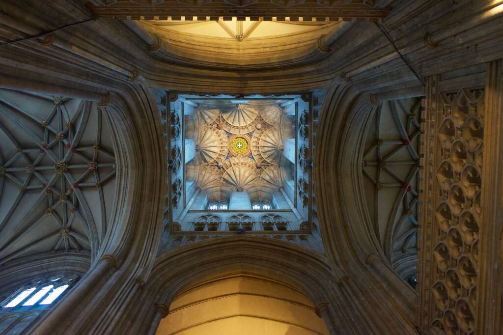 A stunning low angle view of Gothic architecture in Canterbury Cathedral, England.