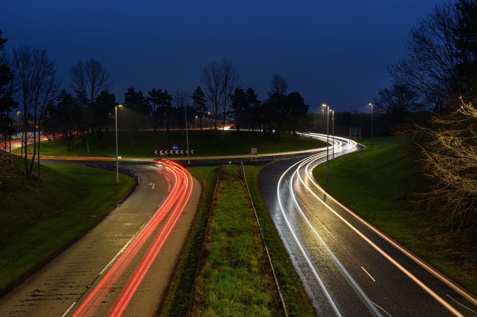 Long exposure of vehicle light trails on a roundabout in Craigavon, UK, at night.