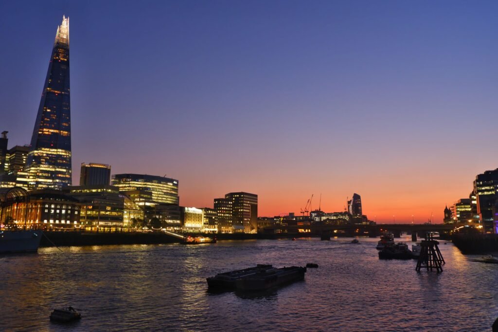 A breathtaking view of London's skyline with The Shard illuminated against a sunset backdrop.