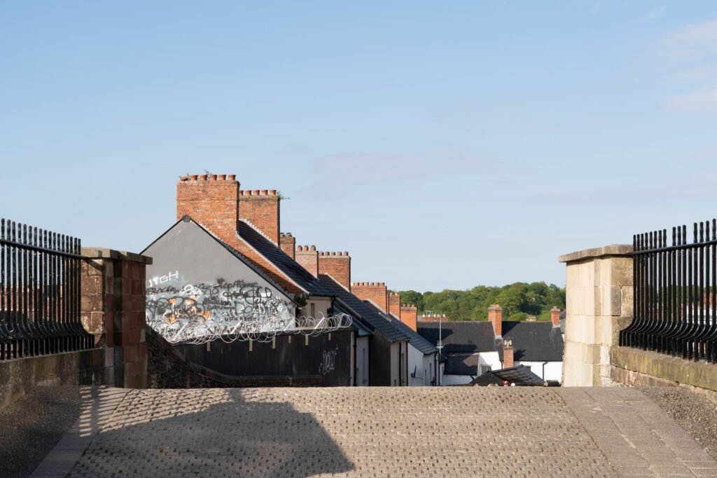 Picturesque Irish street with traditional brick buildings and blue sky in the background.