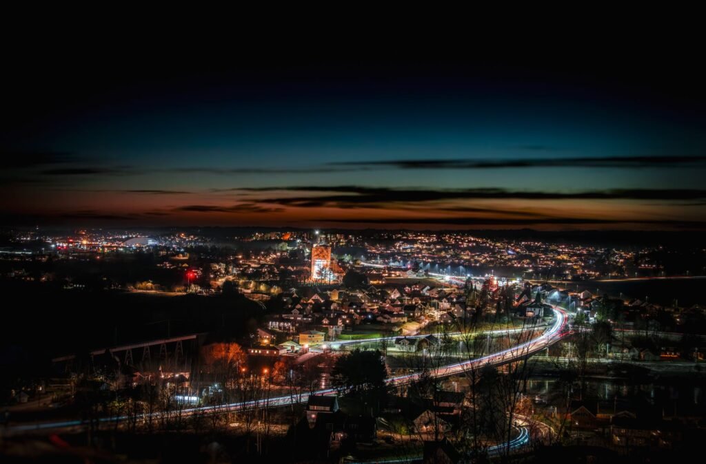 Capture of a stunning cityscape during twilight, showcasing vibrant city lights and dynamic sky.