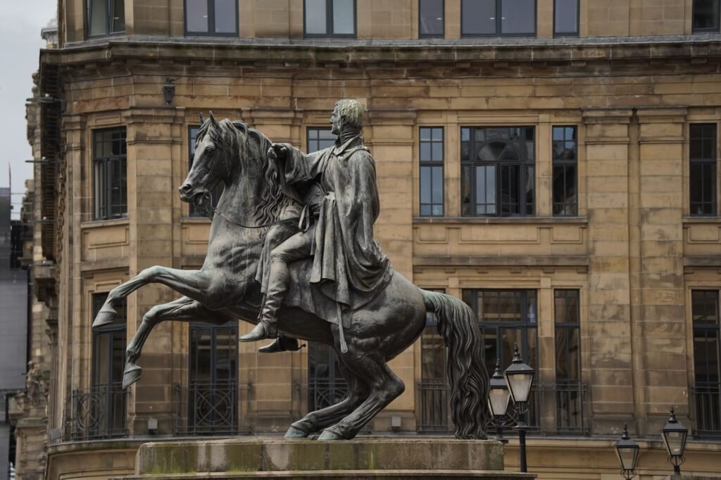 Majestic equestrian statue against classic architecture in Edinburgh, Scotland.