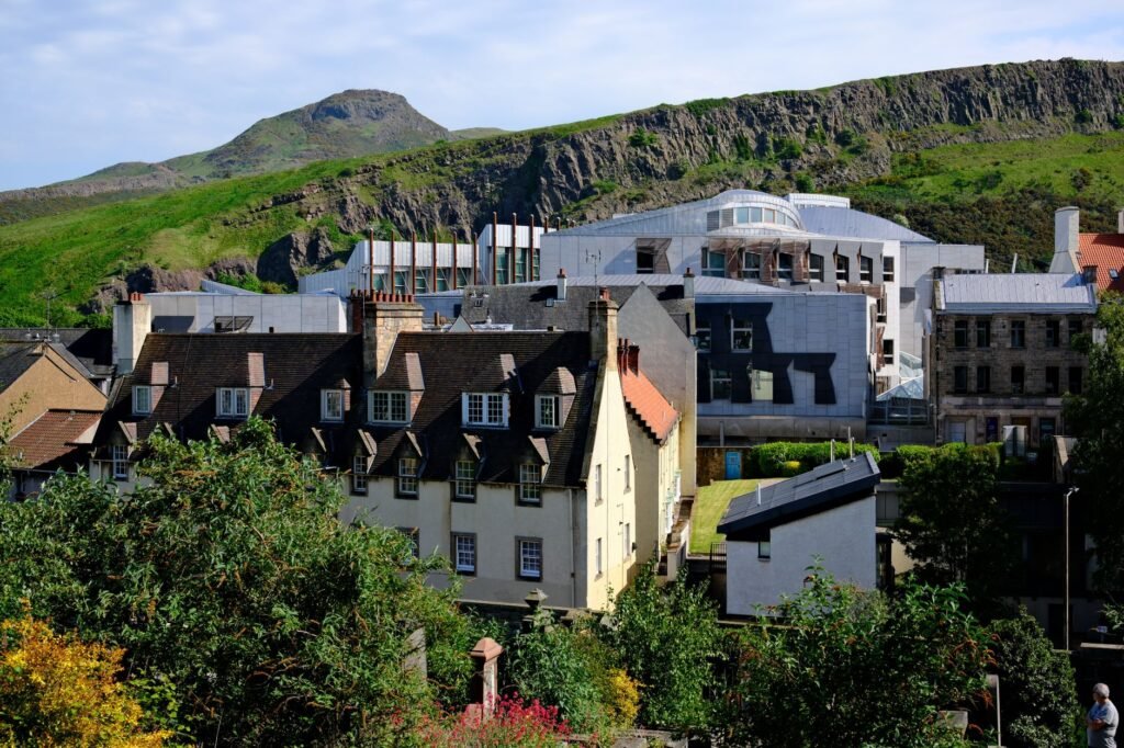 Scenic view of Edinburgh with Arthur's Seat in the background, showcasing historic and modern architecture.