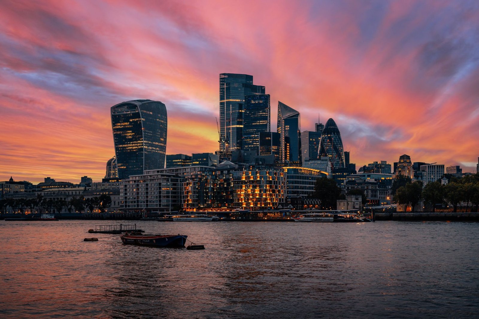 Stunning view of London's skyline with vibrant sunset skies over the river Thames.