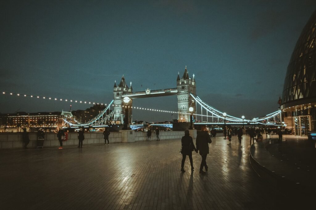 Explore the iconic Tower Bridge illuminated at night, capturing the essence of London's vibrant cityscape.