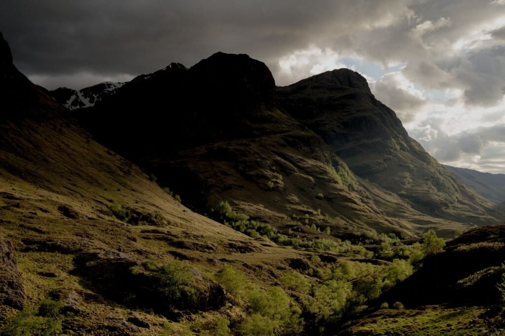 A breathtaking view of a mountainous landscape under a dramatic cloudy sky.