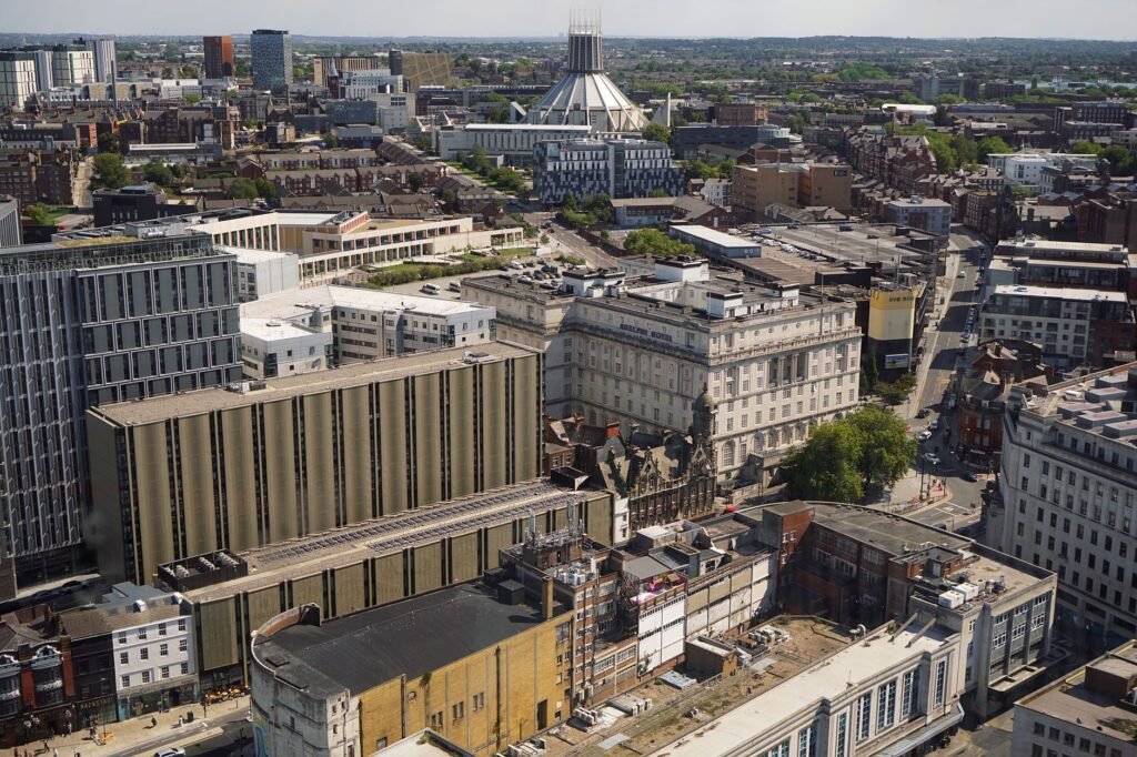 Aerial cityscape featuring a mix of modern and historic architecture, with prominent landmarks visible.