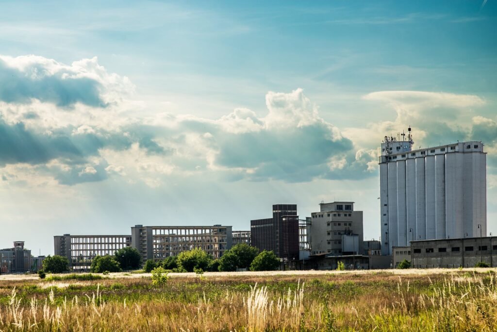 Urban industrial landscape showcasing factories against a cloudy sky in Prostějov, Czech Republic.
