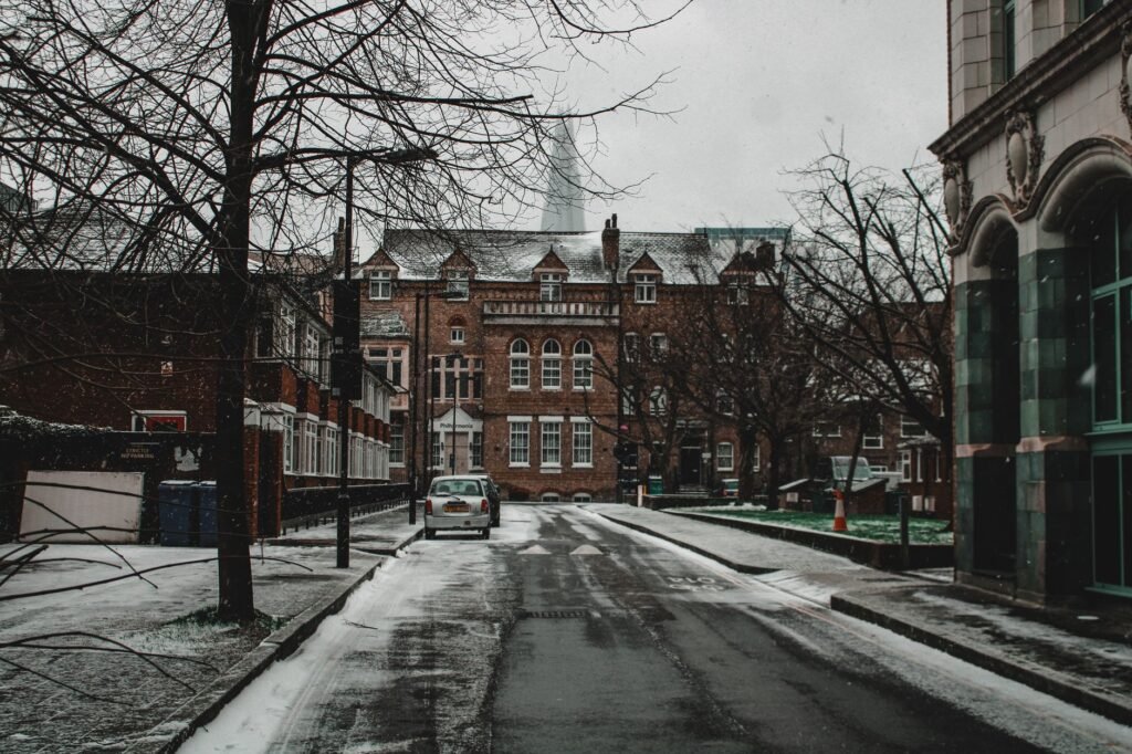 A moody winter street scene in Southwark, London, featuring snow-covered roads and historic architecture.