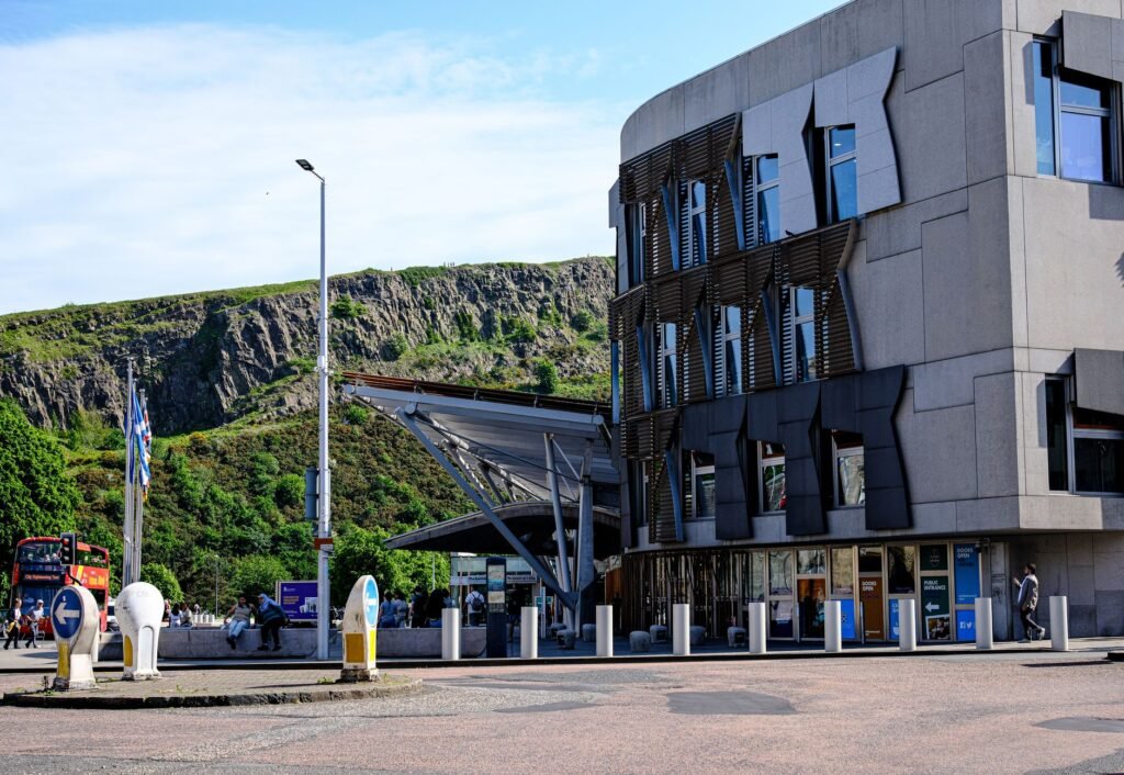Contemporary building exterior near Arthur's Seat in Edinburgh, showcasing urban design against natural backdrop.