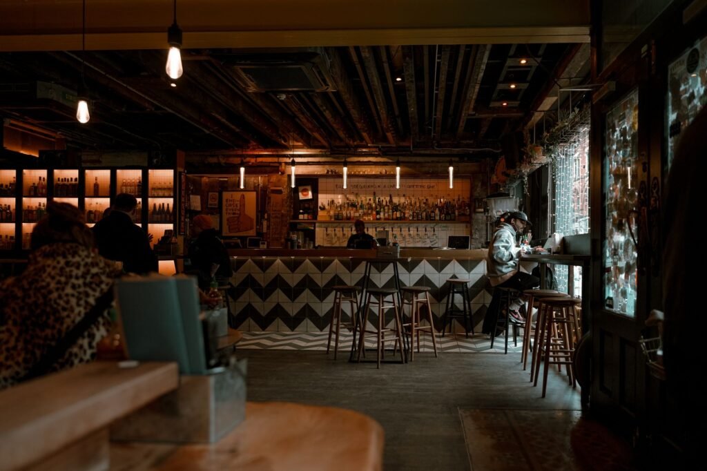 A cozy urban bar in England with warm, cinematic ambiance and vintage decor.