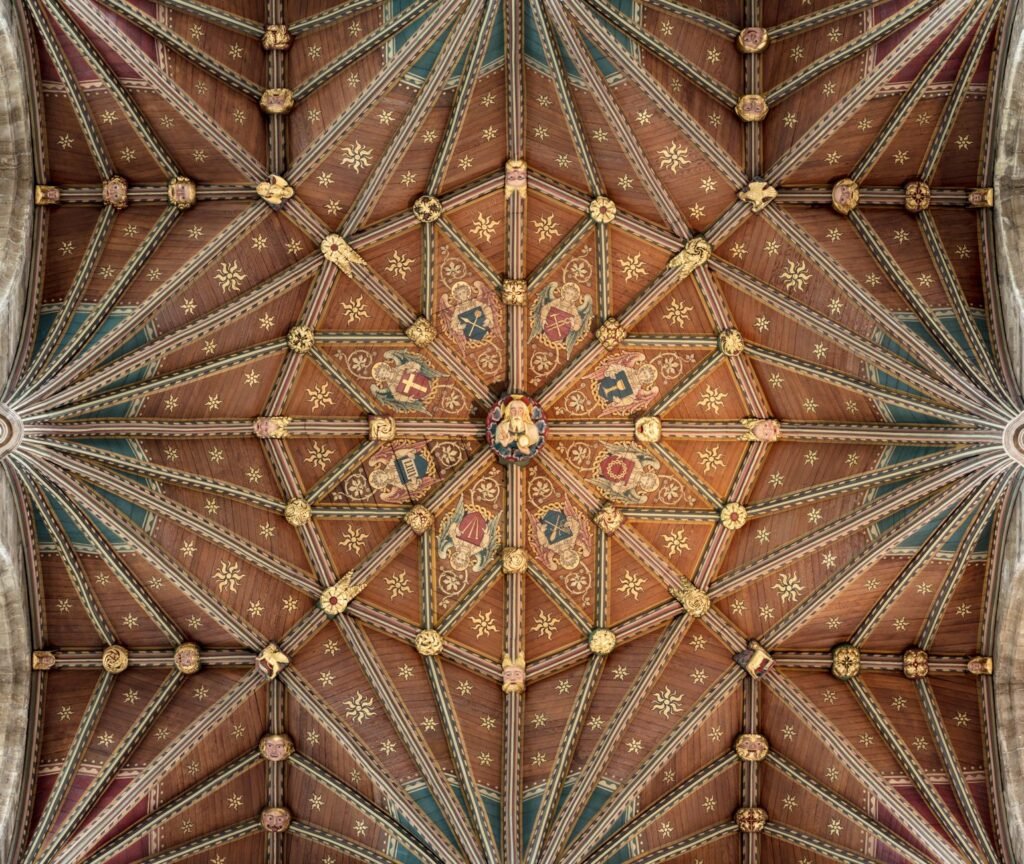 Detailed view of the ornate ceiling in Peterborough Cathedral, showcasing geometric designs and historical art.