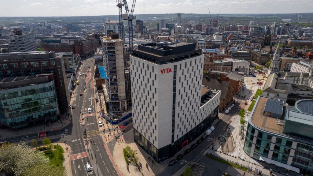 Aerial shot capturing modern architecture in Leeds, England under sunny skies.