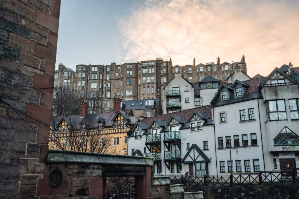 View of iconic Edinburgh architecture at dawn with historic buildings and stunning sky.
