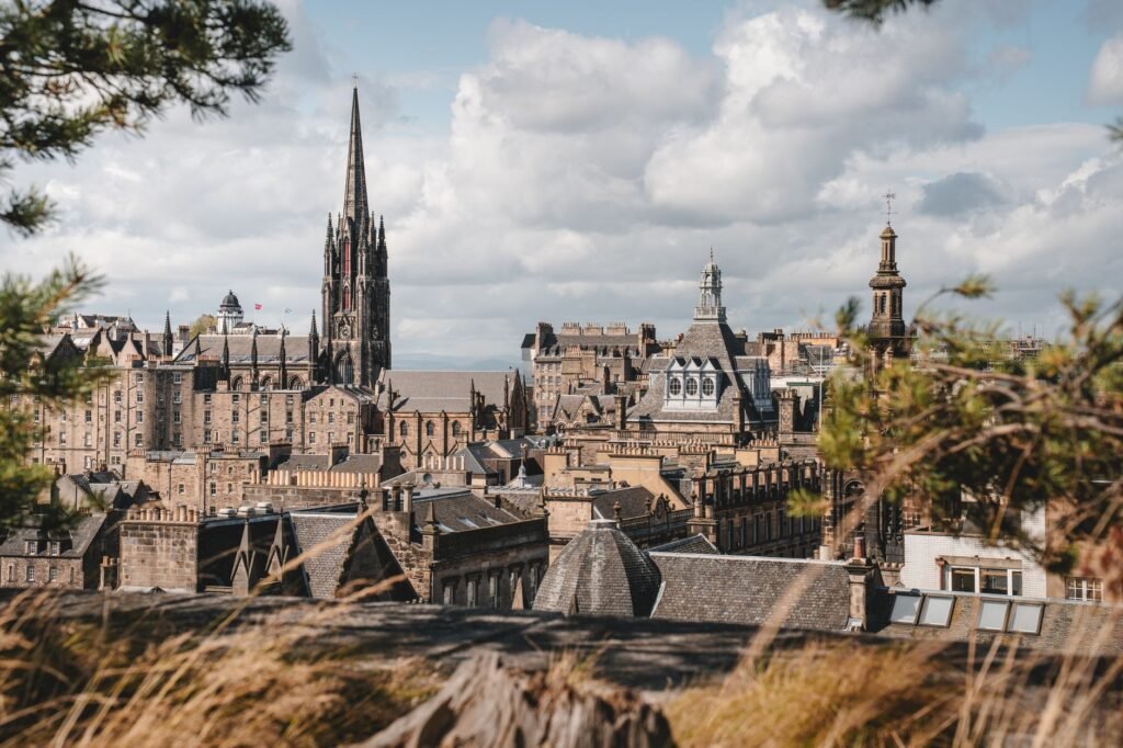 Stunning view over Edinburgh showcasing historical architecture under a dramatic sky.
