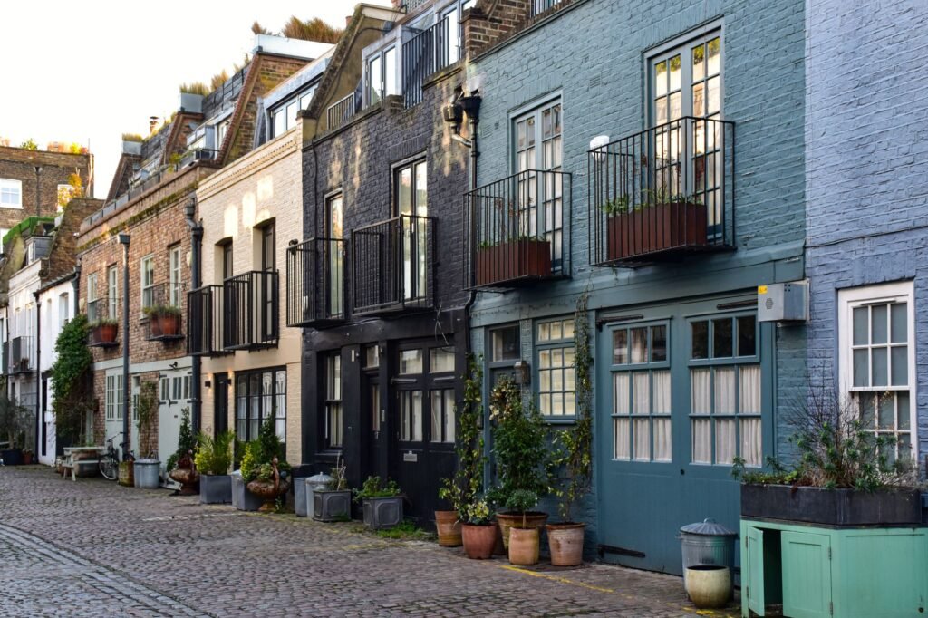 Picturesque row of historic mews houses in a quiet London alley, showcasing charming architecture.