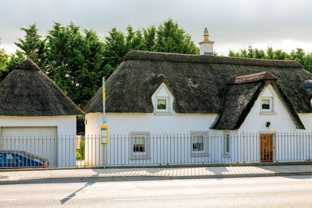 A picturesque thatched cottage in Navan, MH, Ireland, showcasing traditional architecture.