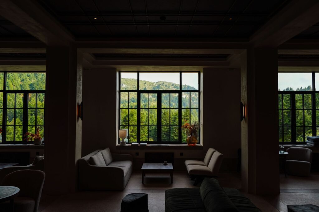Elegant lounge interior with a breathtaking mountain view through large windows.