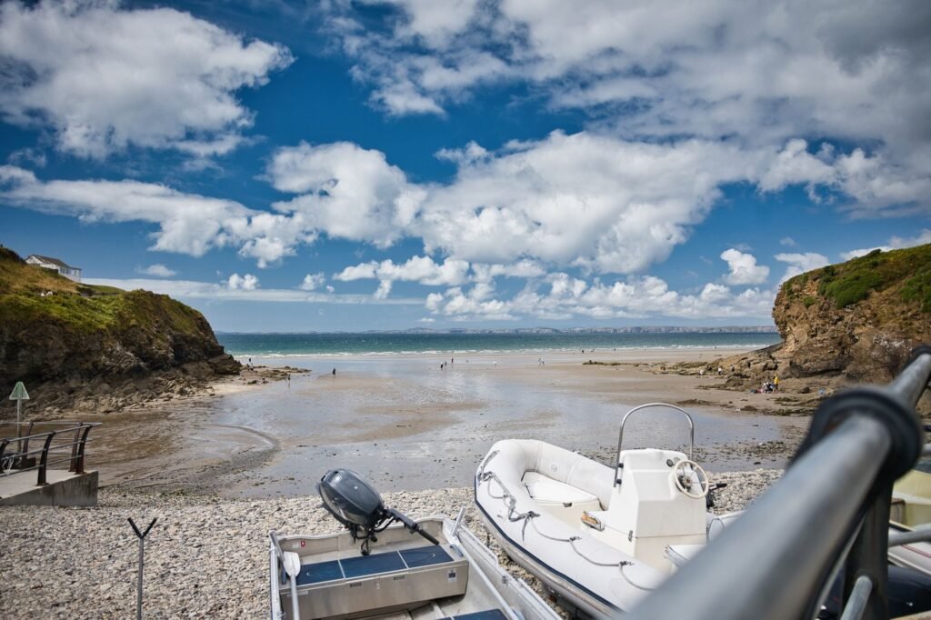 Stunning coastal landscape with a boat and beach at low tide in Wales, UK.
