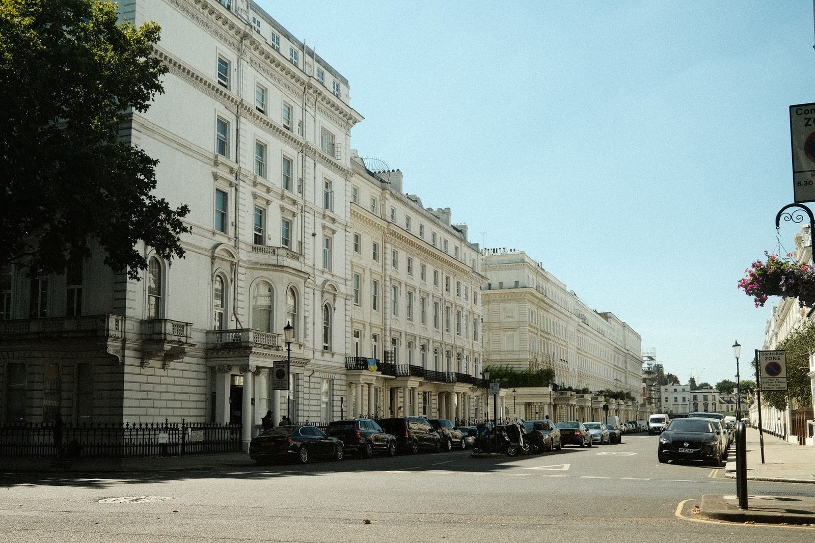 Elegant neoclassical facades line a quiet street in London, England, UK.