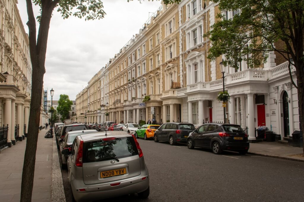 Captivating view of a classic London street with historic row houses and parked cars.