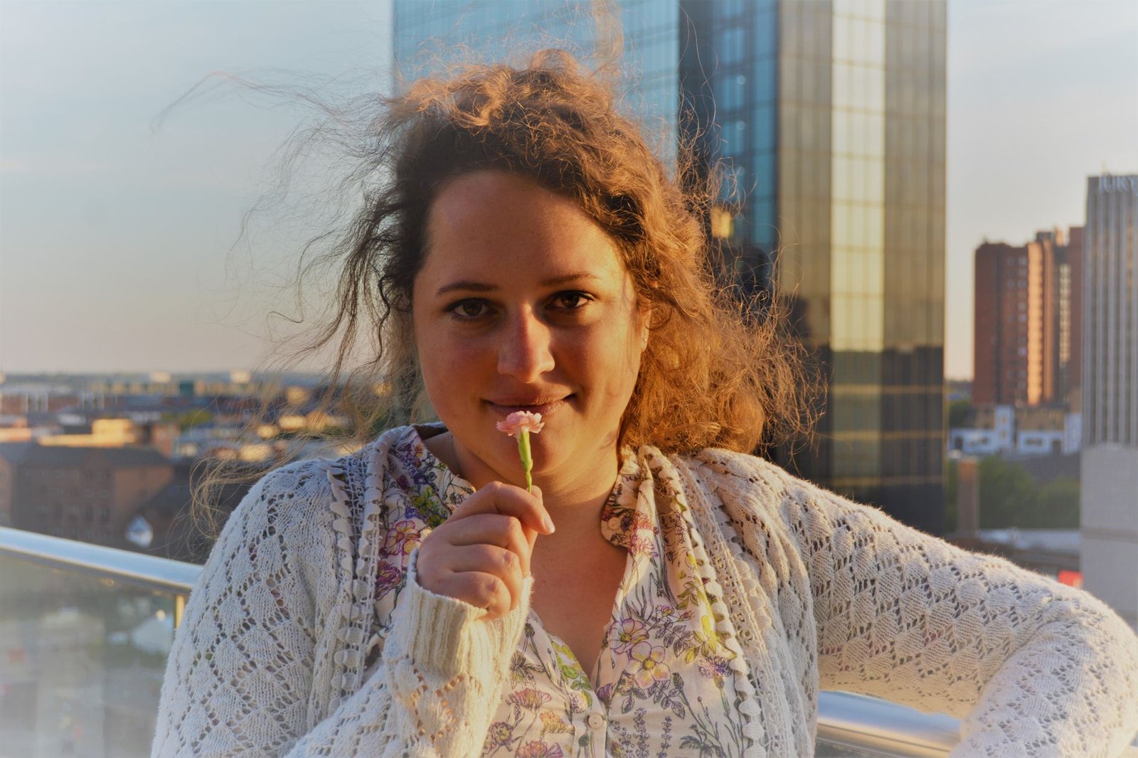 Woman enjoying a sunset view from a rooftop in Derby, England.
