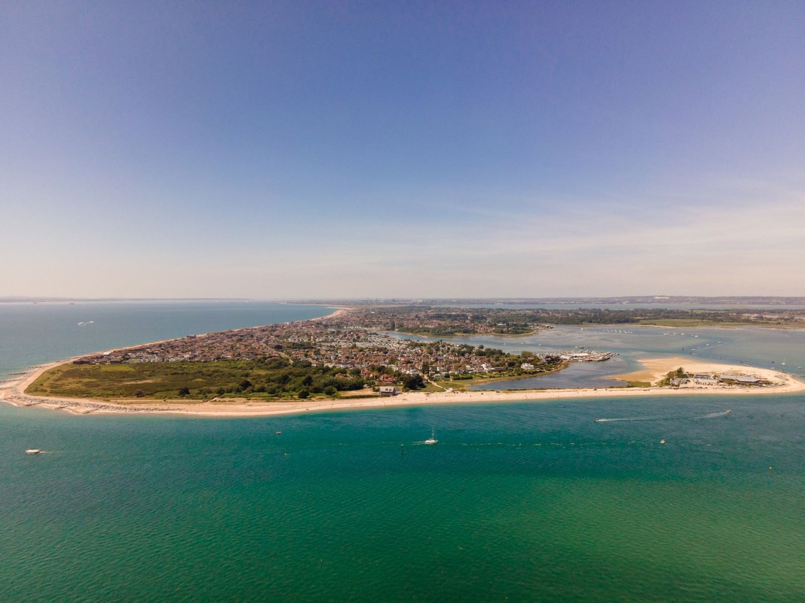 Stunning aerial view of Hayling Island's coastline with clear blue skies and vibrant seascape, offering a breathtaking summer