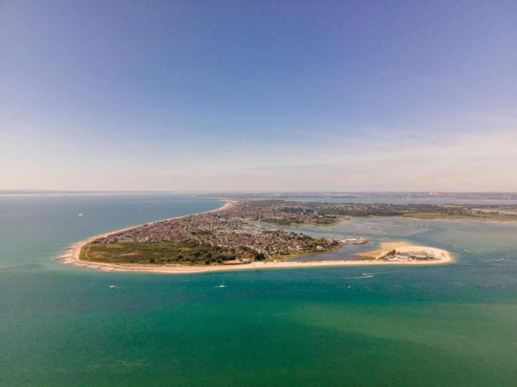 Breathtaking aerial view of the West Wittering coastline in the UK, showcasing the vibrant sea and landscape.