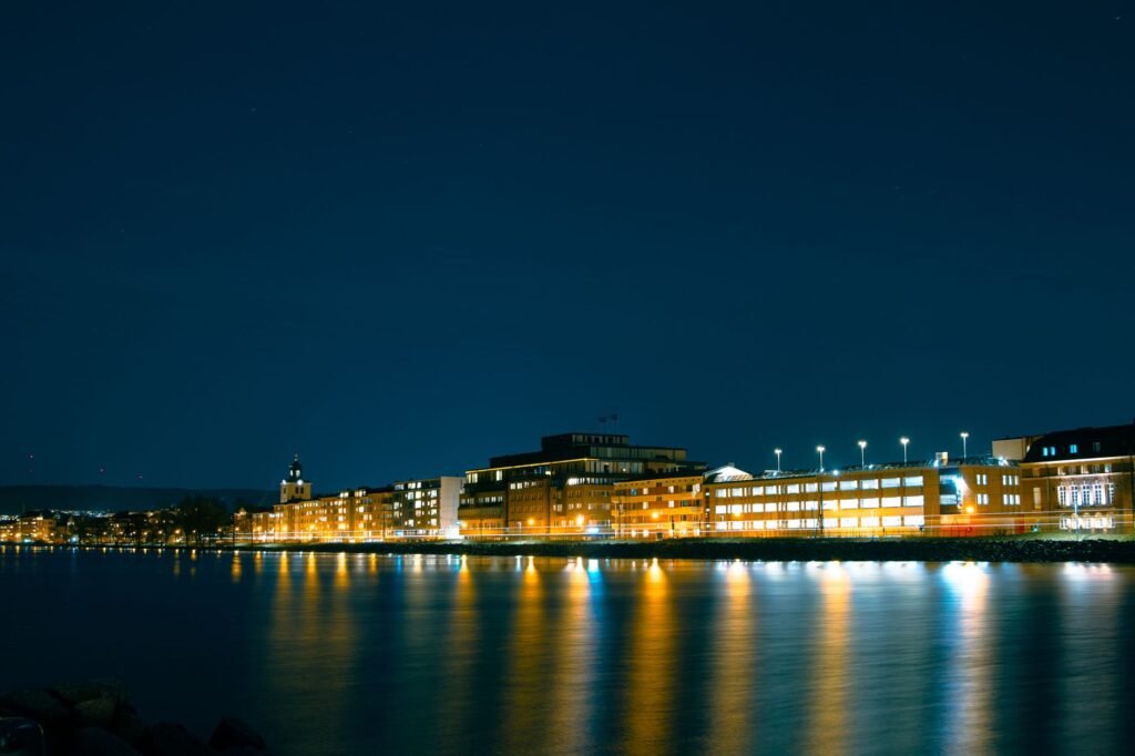 Stunning night view of illuminated waterfront buildings in Jönköping, Sweden.