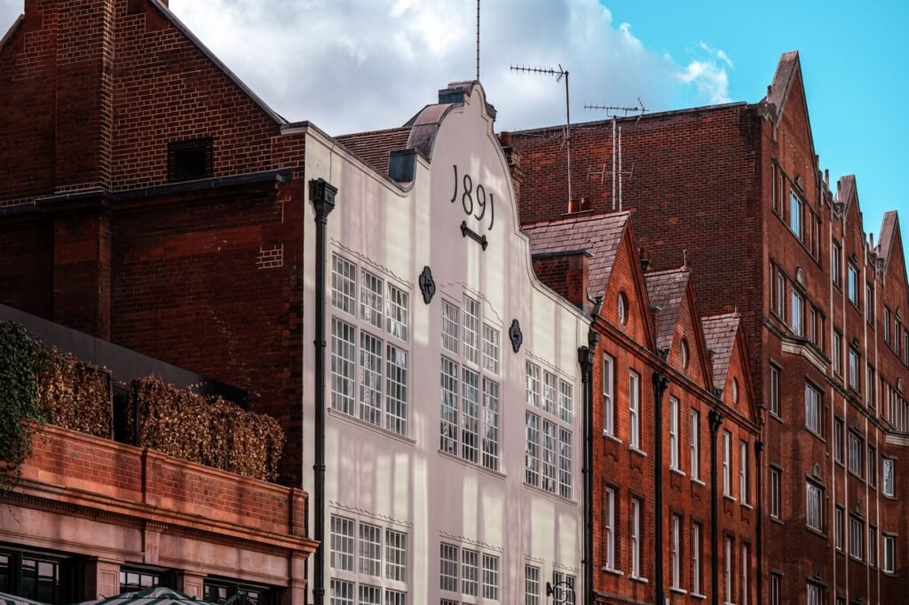 Charming historic buildings in London with a prominent 1891 date on one facade.