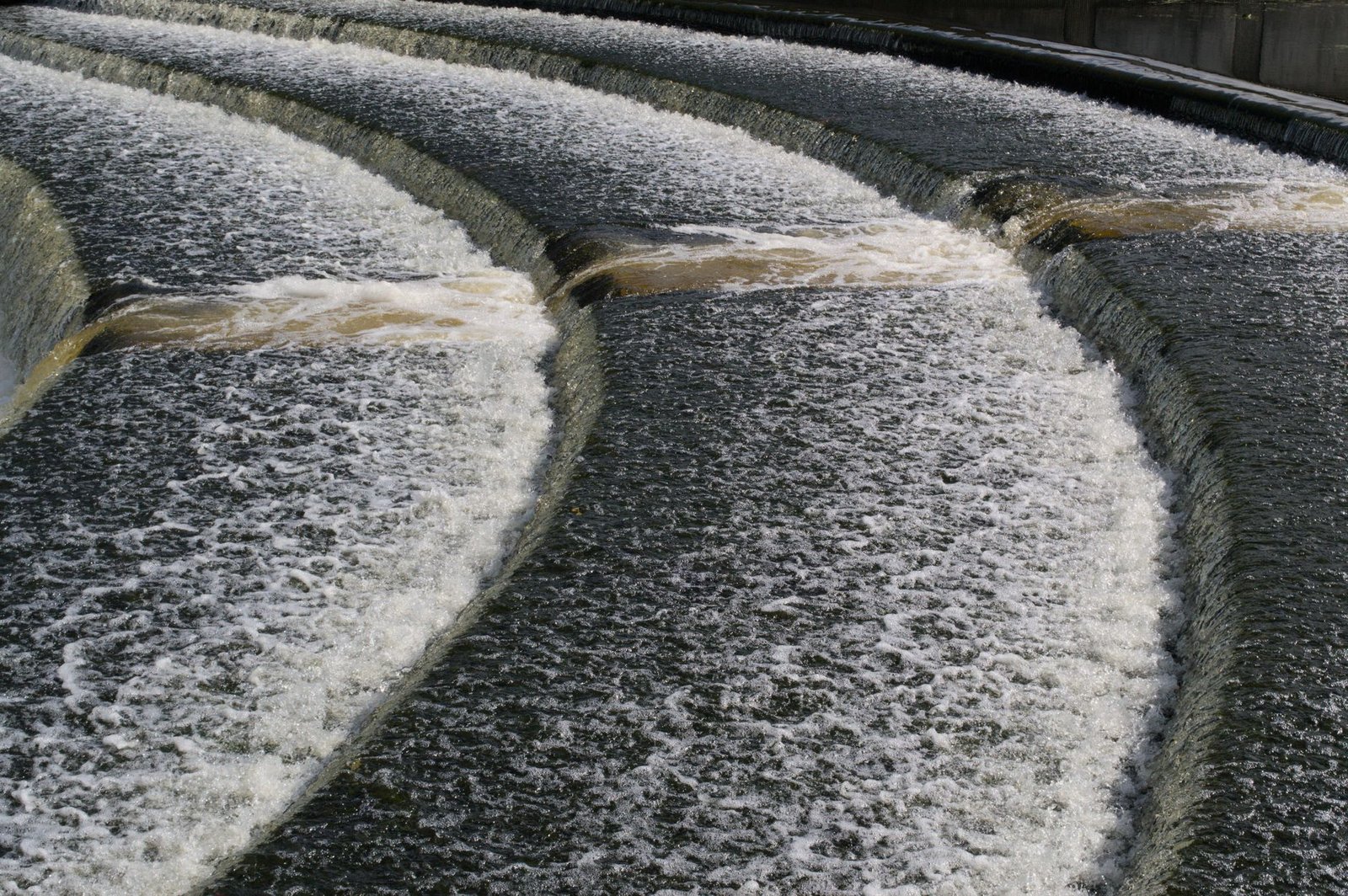Dynamic view of a cascading waterfall over concrete steps in Lisburn, Northern Ireland.