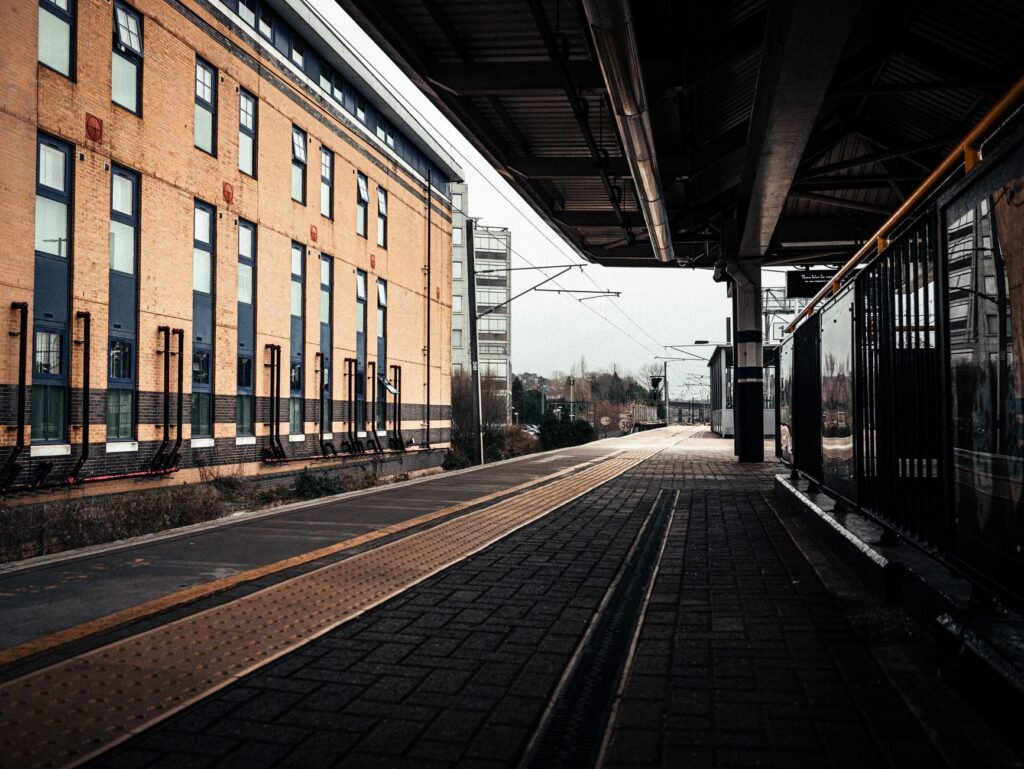 Deserted train station platform in London, showcasing urban architecture and railway tracks.