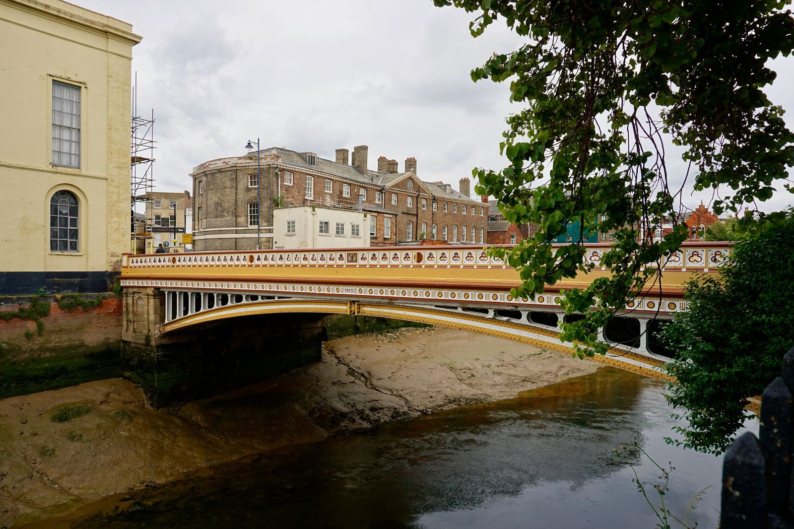 Scenic view of a historical bridge over a river in Boston, England, surrounded by classic architecture.