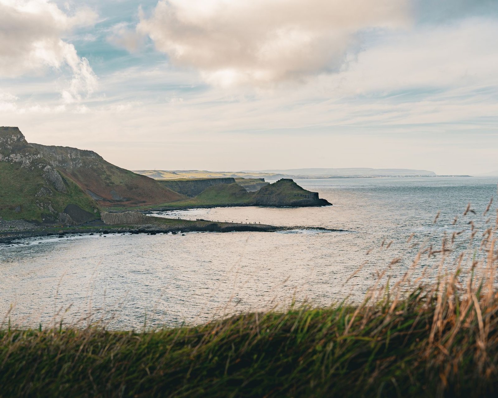 Beautiful coastal landscape in Bushmills, Northern Ireland with rolling hills and ocean view.