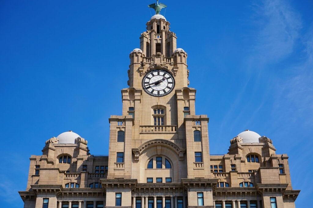 A stunning view of the Royal Liver Building's clock tower in Liverpool under a clear blue sky.