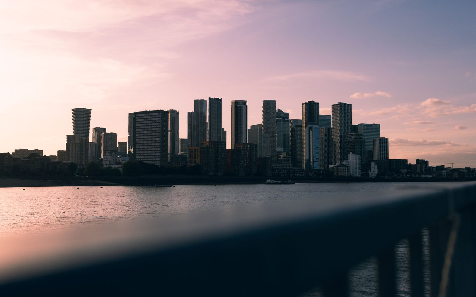 A serene view of London's skyline silhouetted against a colorful sunset backdrop.