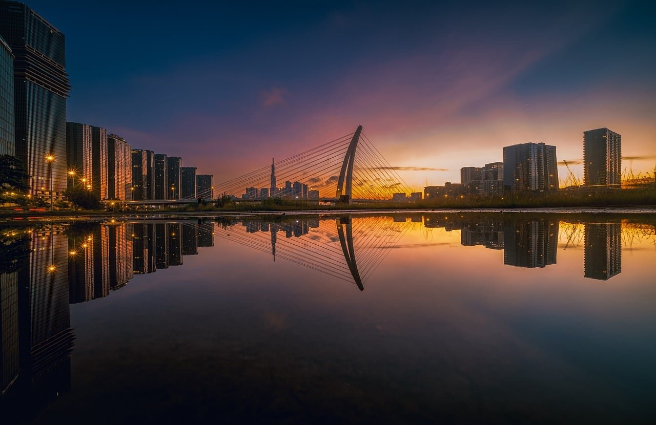 cityscape, bridge, reflection, sunset, skyscrapers, river, modern architecture, night lighting, urban river, building, nature