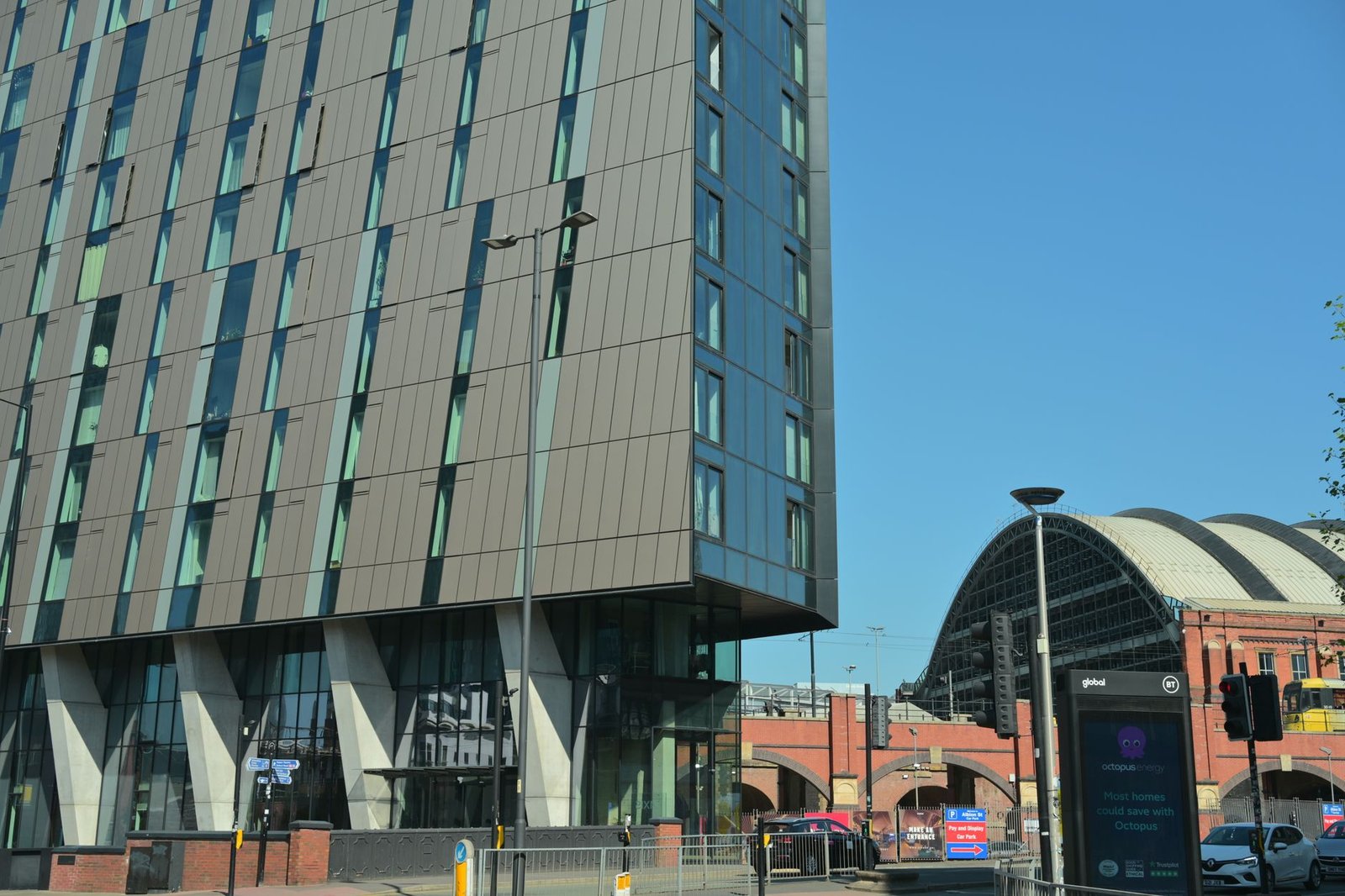 Contemporary architecture next to a train station on a sunny day.