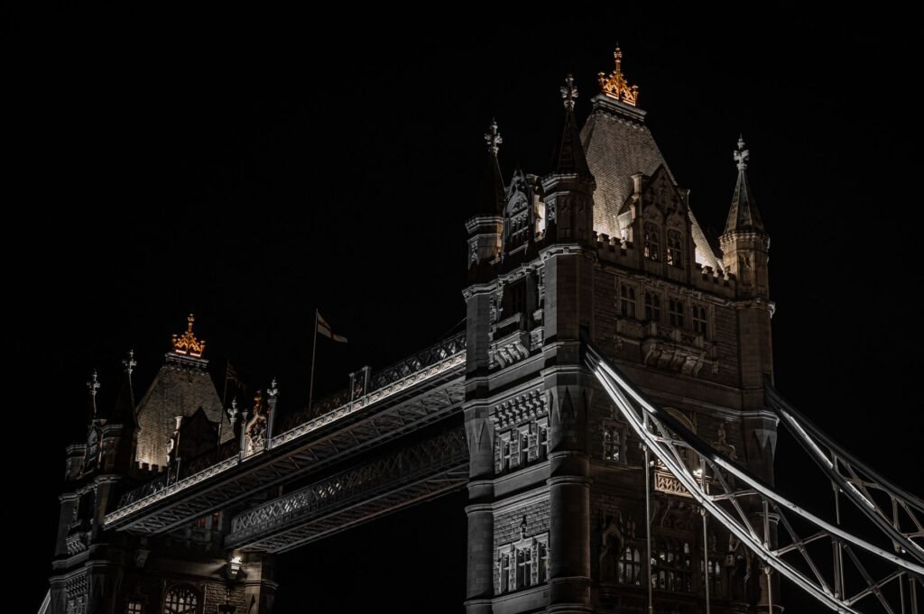 Night view of London’s iconic Tower Bridge with dramatic lighting.