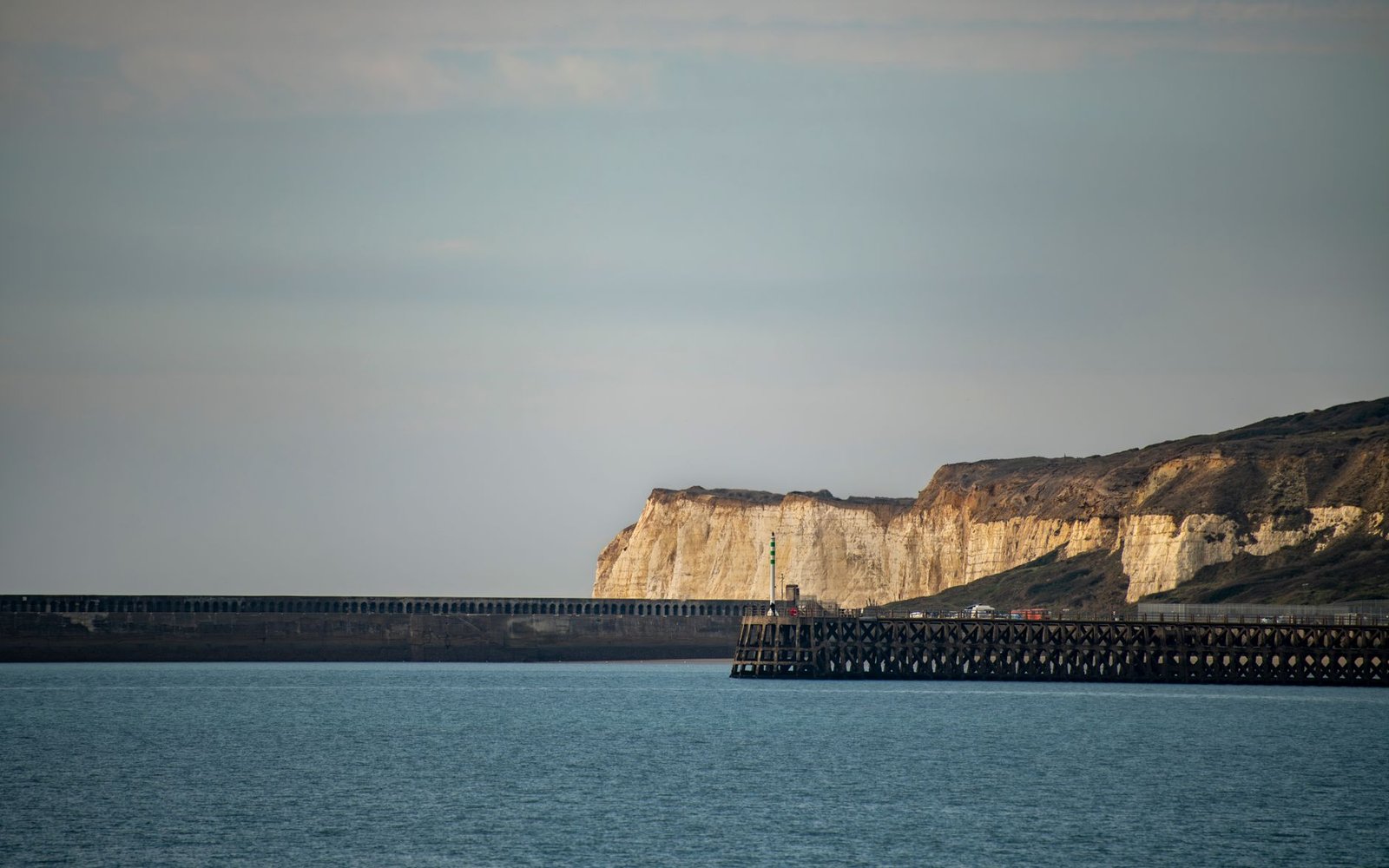 A beautiful view of the white cliffs and seafront in Newhaven, England, capturing the serene coastal landscape.