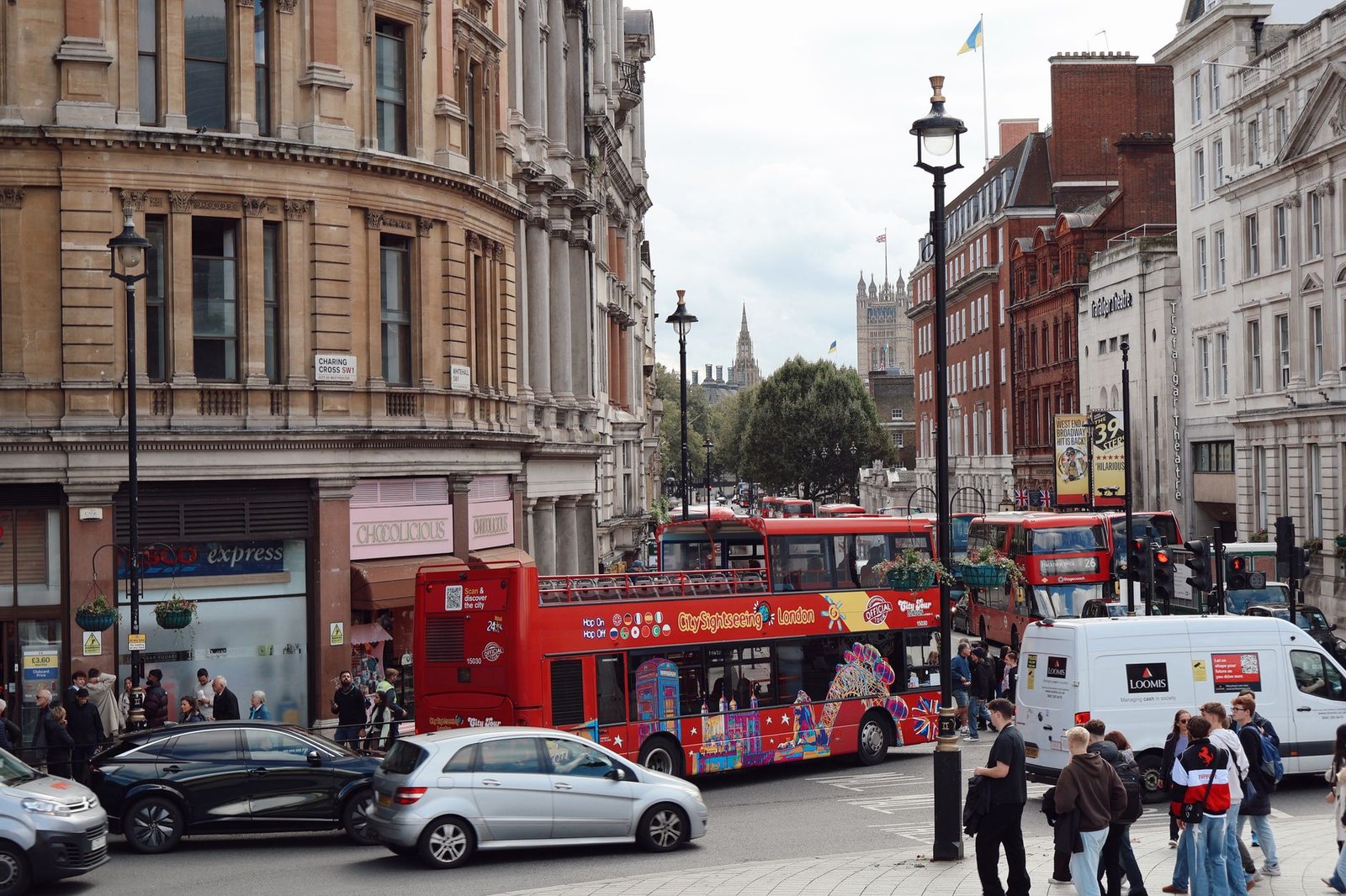 Lively London street scene featuring iconic red buses and classic architecture. Captures the essence of city life.
