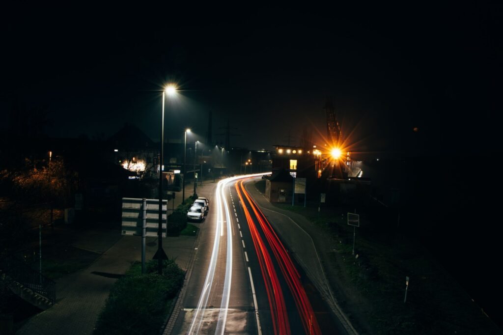 Captivating long exposure photo of urban street with light streaks and traffic at night.