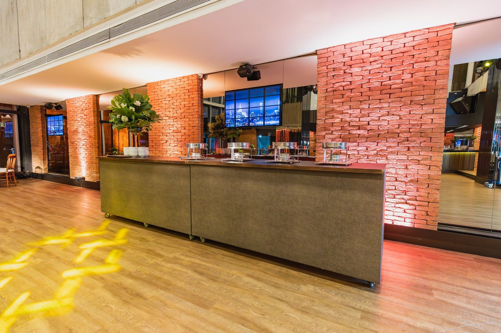 Elegant restaurant interior featuring brick walls and ambient lighting.