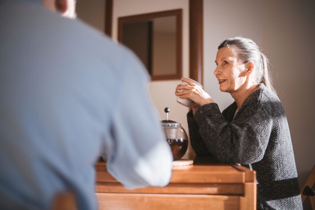 Cheerful senior couple enjoying coffee together in a cozy home setting.